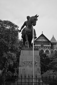 Low angle view of statue against sky