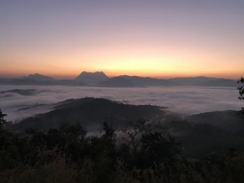 Scenic view of silhouette mountains against sky during sunset