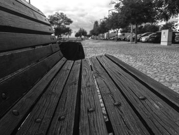 Close-up of bench on footpath