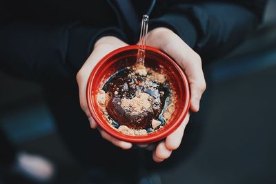 High angle view of hand holding ice cream