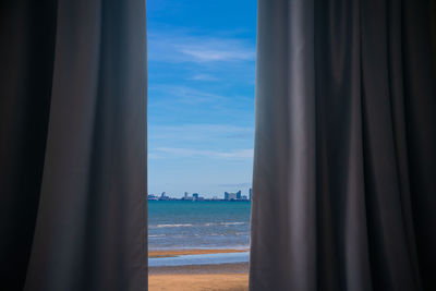 Curtain at the window in the morning. sea view concept