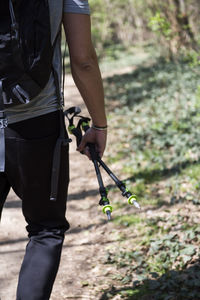 Midsection of man holding hands while standing on land