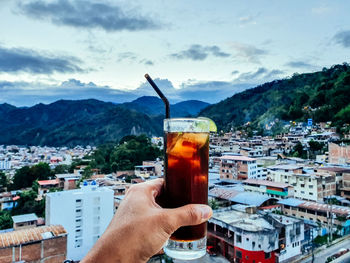 Cropped hand holding drink