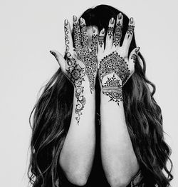 Young woman wearing mask against white background