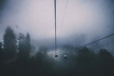 Low angle view of ski lift against sky