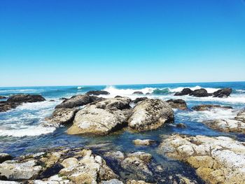 Scenic view of sea against clear blue sky