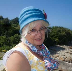 Portrait of senior woman against clear blue sky