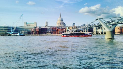 London millennium footbridge by st paul cathedral against sky in city