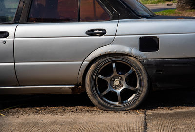 Close-up of vintage car on road