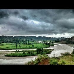 Scenic view of landscape against cloudy sky