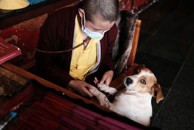 Midsection of man holding dog