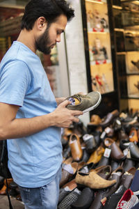 Man choosing shoes in market