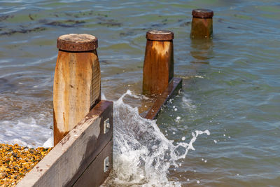 Wooden posts in sea