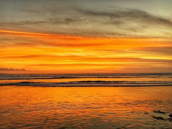 Scenic view of sea against orange sky