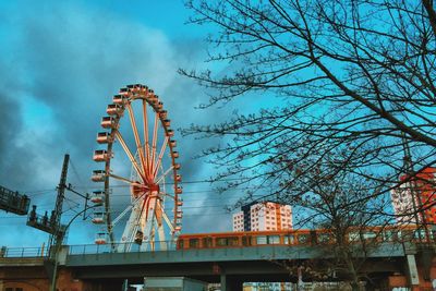 Low angle view of ferris wheel against sky