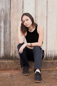 Beautiful young woman sitting outdoors