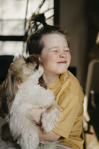 Dog licking boy's cheek at home