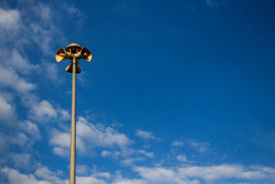 Low angle view of street light against blue sky