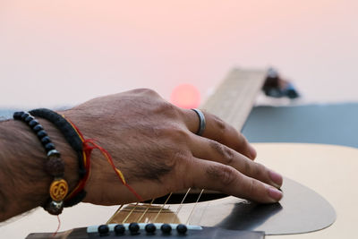 Playing guitar during sunset