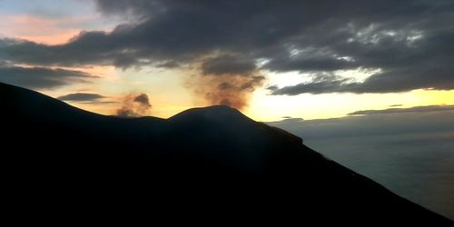 Scenic view of silhouette mountains against sky during sunset