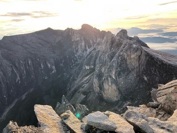Rocks in mountains against sky during sunset