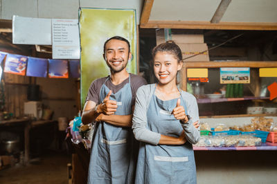 Portrait of smiling friends standing in store