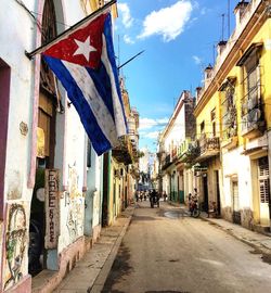 Flags in city against sky