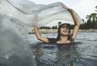 Close-up of girl holding plastic in sea