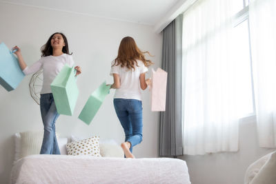 Woman standing against wall at home