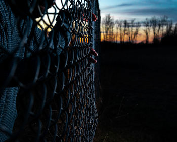 Close-up of chainlink fence against sky