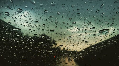 Full frame shot of wet glass window in rainy season