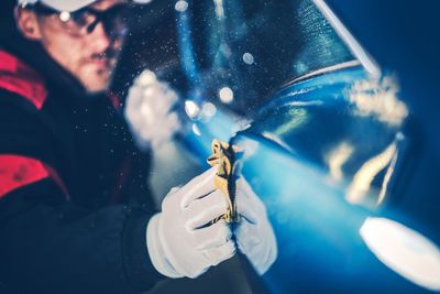 Close-up of man holding umbrella