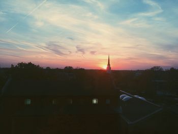 Silhouette of buildings against sky during sunset