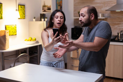 Young couple standing on table