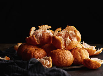 Close-up of oranges on table against black background