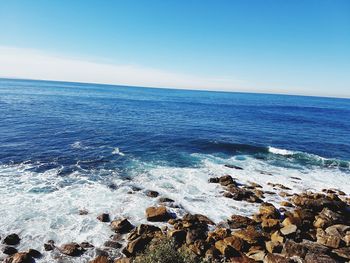 Scenic view of sea against clear blue sky