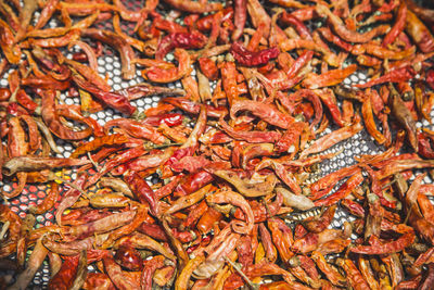 Full frame shot of red chili peppers on floor