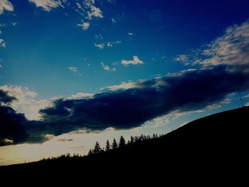 Low angle view of silhouette mountain against sky at sunset