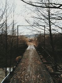 Close-up of wet railroad track against sky