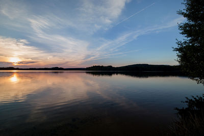 Scenic view of lake against sky at sunset