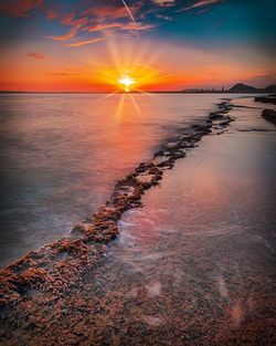 Scenic view of sea against sky during sunset