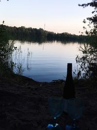 Scenic view of lake against sky at sunset