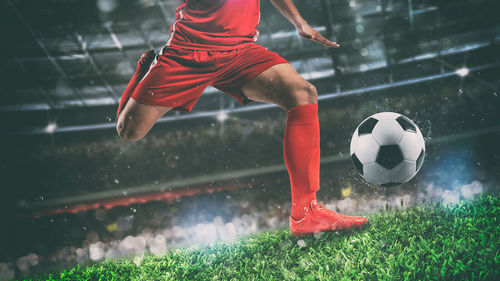 Woman playing soccer ball on field