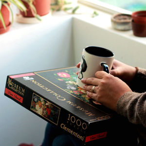 Midsection of man holding coffee cup on table