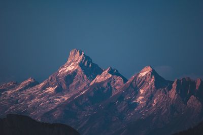 Scenic view of snowcapped mountains against clear blue sky