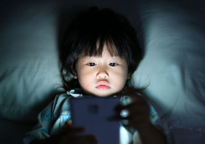 Portrait of cute girl using mobile phone