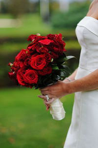 Close-up of woman holding pink flower