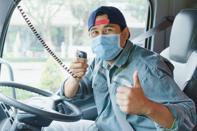 Portrait of man sitting in bus