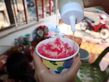 Close-up of hand holding ice cream