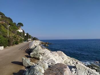 Scenic view of sea against clear blue sky